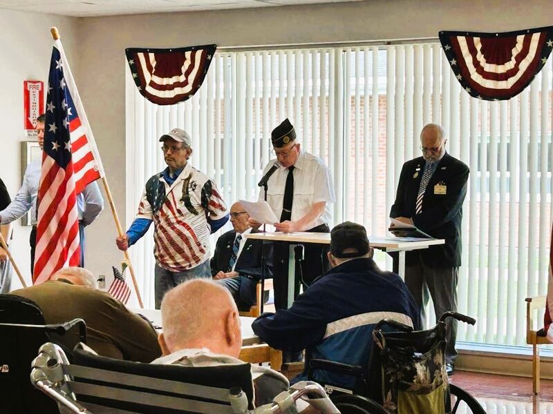 Oglesby Elk and American Legion member Jim Ebner addressed June 14, 2025, residents of the Illinois Veterans Home at La Salle. Elk Esquire Tim Watkins holds one of the American flags while Oglesby Elks Exalted Ruler Bill Gandolfi looks on.