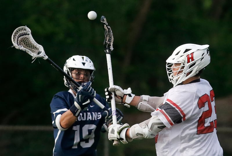 Huntley's Dominic Scarpelli (right) passes the ball as Cary-Grove's Wyatt Judge defends during the Marian Central Sectional boys lacrosse semifinal match on Wednesday, May 28, 2025, at Marian Central High School in Woodstock.