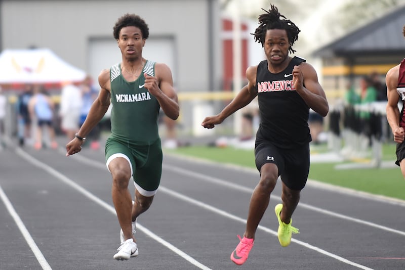 Bishop McNamara's Dashaun Whiters, left, and Momence's Marchello Draine race in the 100 m dash at the Herscher Invite Friday, May 2, 2025.