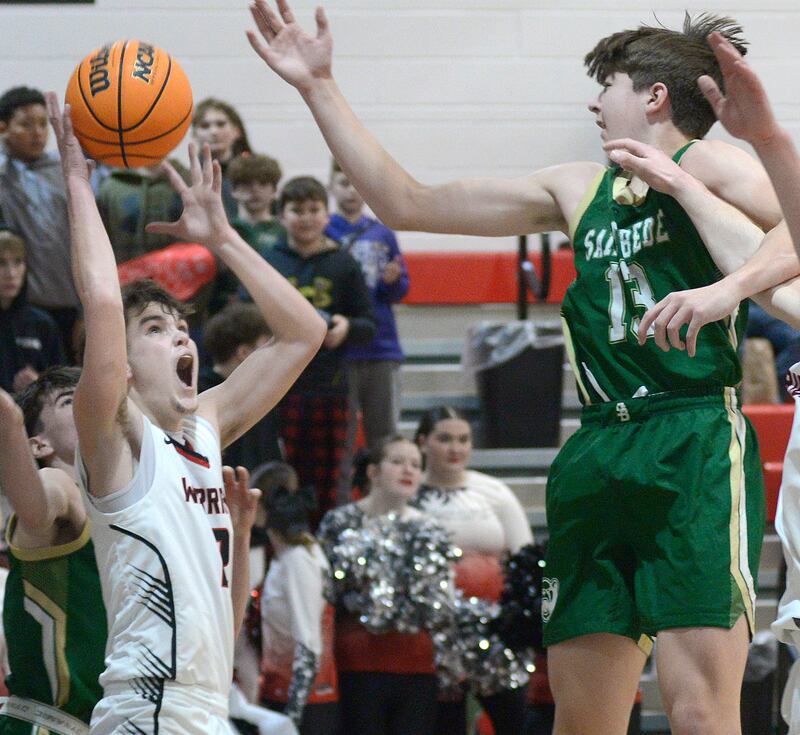 Woodland’s Nolan Price works to get this shot past the block attempt by St Bede’s Graham Ross  in the 2nd quarter Friday at Woodland.