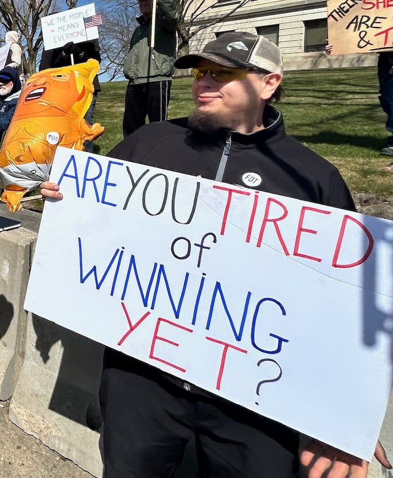 Jeremy Ritzert holds a sign that reads "Are You Tired of Winning Yet?" at the No Kings protest Saturday on the Old Lee County Courthouse lawn in Dixon.