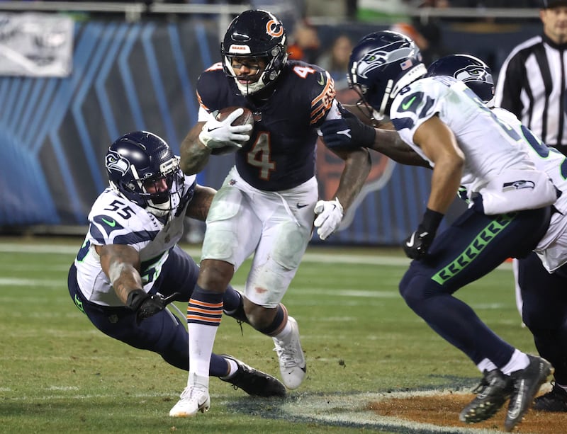 Chicago Bears running back D'Andre Swift carries the ball past Seattle Seahawks defensive end Dre'Mont Jones during their game Sunday, Dec. 26, 2024, at Soldier Field in Chicago.