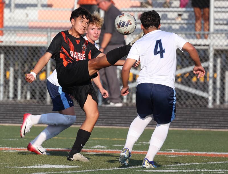 DeKalb's Nathan Ramirez kicks the ball out from between two Guilford players during their game Thursday, Sept. 18, 2025, at Dekalb High School.