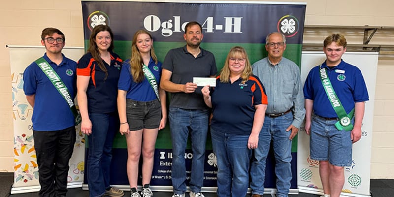 Daniel Carmichael and Greg Cross present a check to Ogle County 4-H. Pictured left to right: Immanuel Arellano, Ogle County 4-H ambassador; Anna Henson, Ogle County office support; Allissa Martin, Ogle County 4-H ambassador; Carmichael, Rochelle; Jodi Baumgartner, Ogle County 4-H program coordinator; Greg Cross, Polo Lions Club member; and Josh Snow, Ogle County 4-H ambassador.