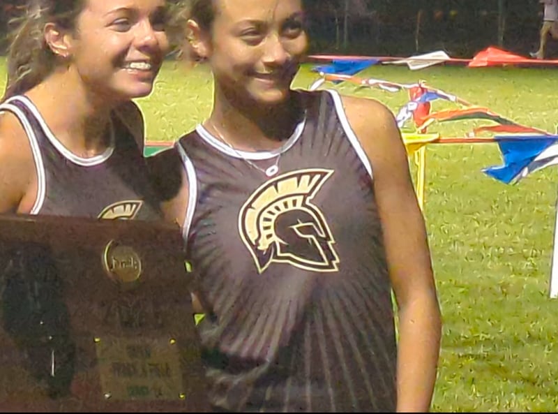 The Sycamore girls track team celebrates as its name is announced after winning the Class 2A Genoa-Kingston Sectional on Friday, May 15, 2026.