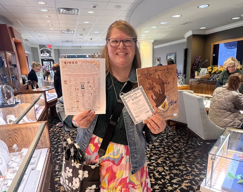 Kristen Cornelio holds a Gilmore Girls-themed bingo card for downtown Geneva shoppers to win some prizes – including a signed Gilmore Girls script. She set up the promotion through her marketing company, Kristen Holly LLC. Shoppers get the squares signed and for each completed bingo, they are eligible for a raffle ticket to win prizes.