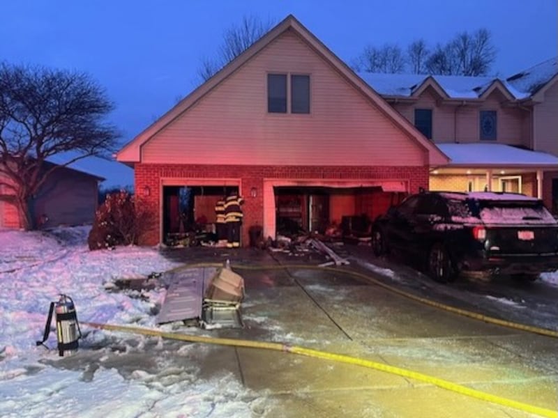 Firefighters examine a garage which caught fire in the early hours of Jan. 31 in the 16700 block of Swift Arrow Drive.