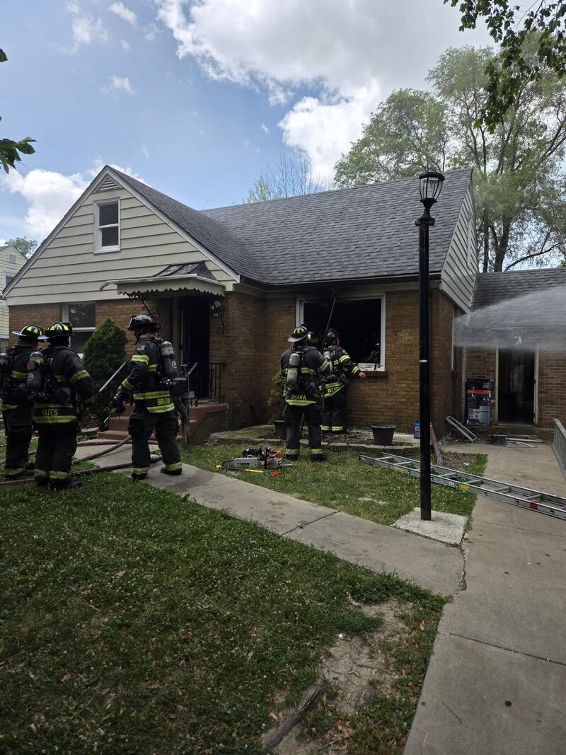 Joliet firefighters outside a house in the 300 block of South May after a house fire broke out on Wednesday, July 2, 2025.