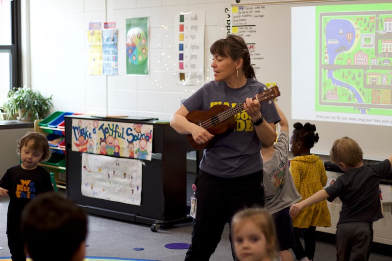 Music teacher Joanne Moan plays guitar with her students on April 29, 2025 at Walsh Elementary School, 514 MacGregor Road, Lockport.
