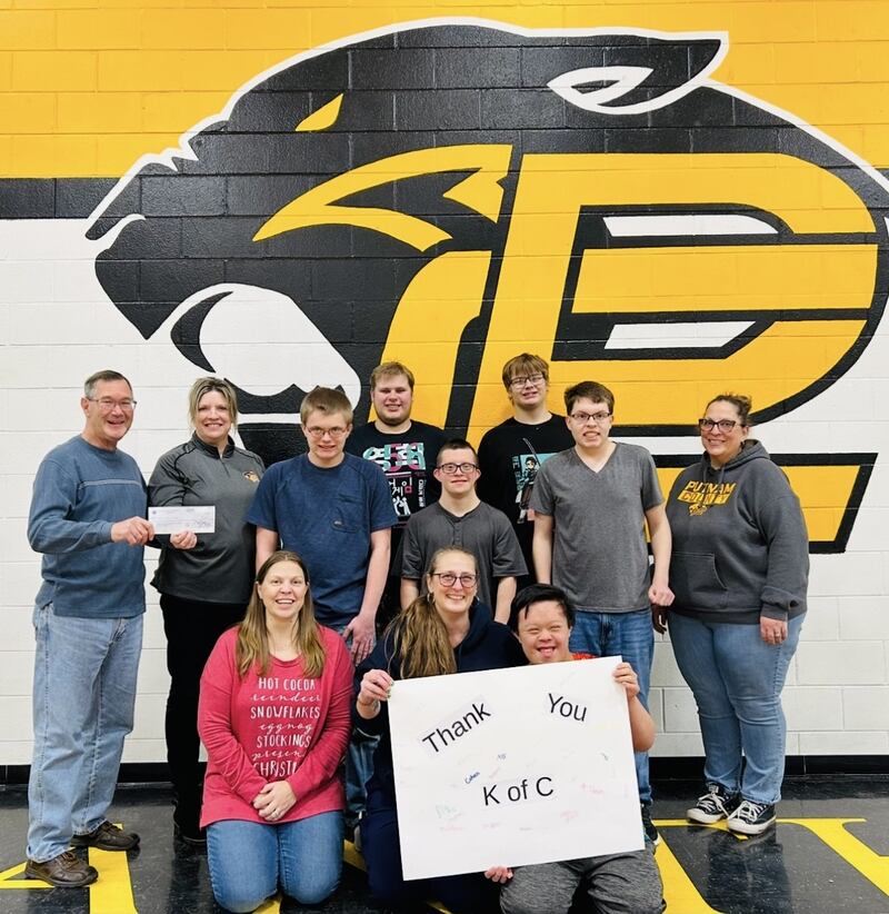 Members of the Granville Knights of Columbus present a $2,482.55 donation from the organization’s annual Tootsie Roll fundraiser to the Putnam County High School Special Education Department. Pictured are Knights of Columbus Co-Chair Chuck Loeback and Jodie Peterson, the district’s director of student services, along with special education teachers and students.