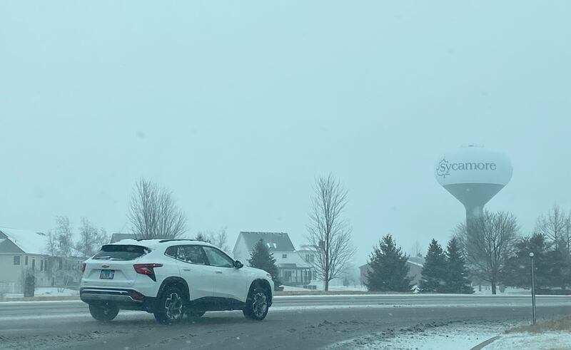 The City of Sycamore water tower looms over Peace Road on a snowy Wednesday, Feb. 12, 2025.