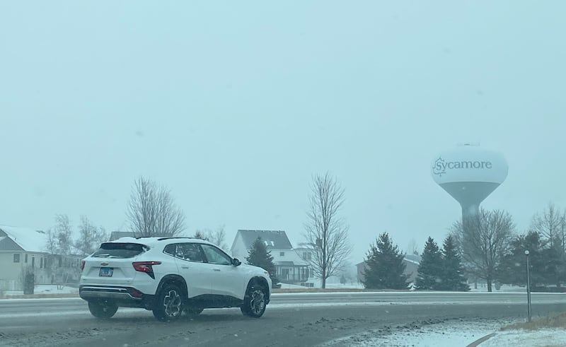 The City of Sycamore water tower looms over Peace Road on a snowy Wednesday, Feb. 12, 2025.