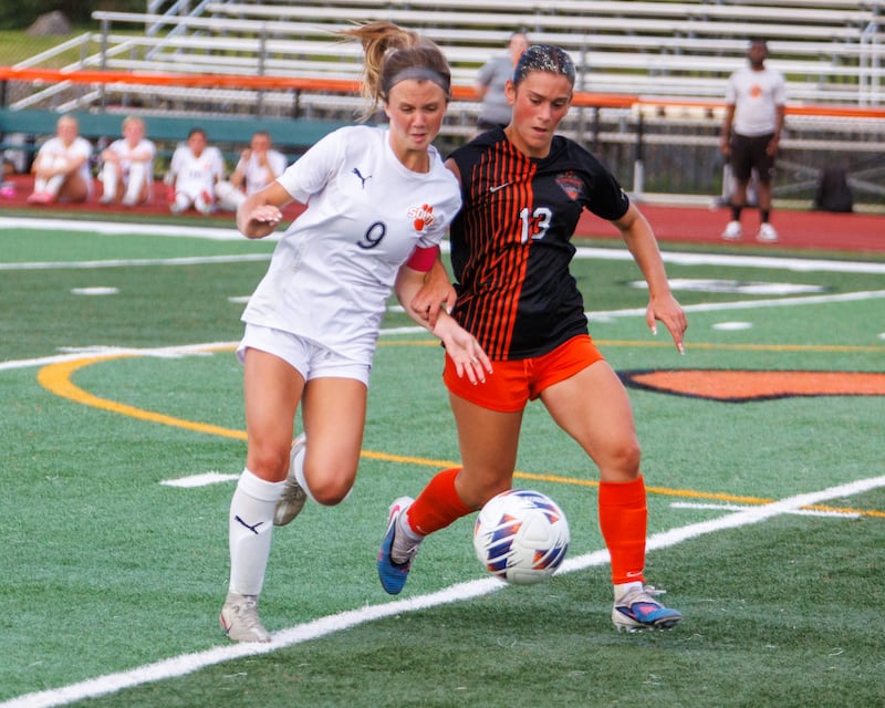 Wheaton Warrenville South's Kelsey Clousing battles for the ball with St. Charles East's Georgia Desario at the Class 3A St. Charles East Sectional Final on Friday, May 29,2026 in St. Charles.