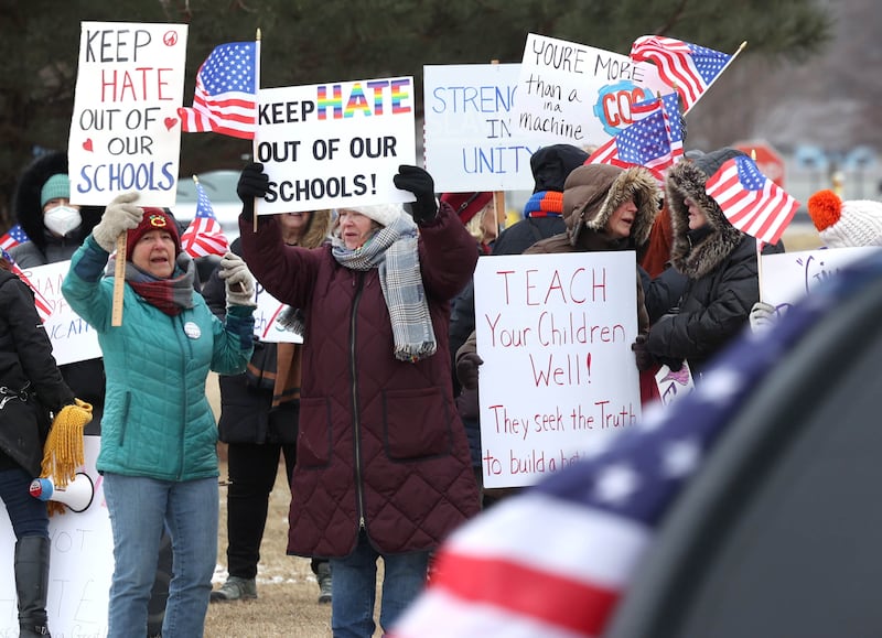 Protesters acknowledge passing vehicles Thursday, Feb. 5, 2026, in front of Genoa-Kingston High School. The group is protesting the “History Rocks” assembly which is part of a nationwide campaign by the U.S Department of Education tied to the nation’s 250th anniversary and organized by the high school’s Turning Point USA, Club America chapter, a nonprofit founded in 2012 by the late Charlie Kirk.