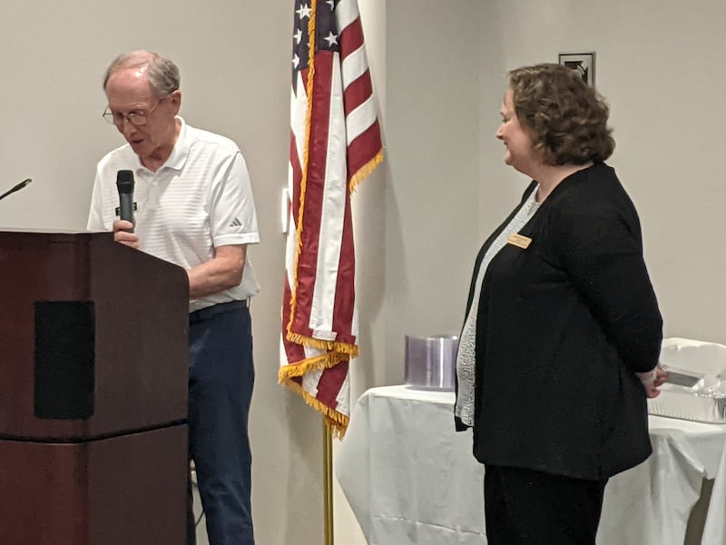 Oswego Library Board President Terry Tamblyn, left, honors outgoing Oswego Public Library District Director Sarah Skilton, right, during her retirement party at the downtown Oswego library campus on Sept. 19, 2025.