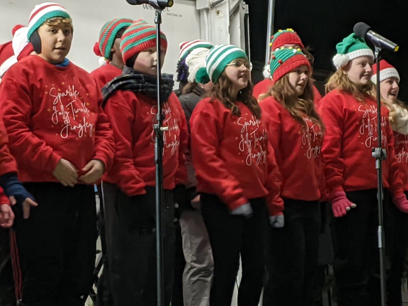 The Traughber Junior High School Chorus sing the song “Sparkle Jolly Twinkle Jingly” from “Elf The Musical” during the Oswego Christmas Walk on Dec. 6.