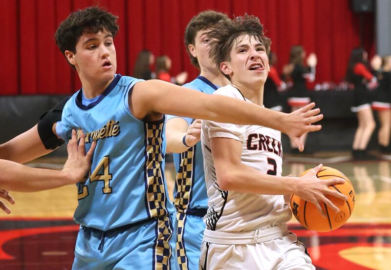 Indian Creek's Jason Brewer goes to the basket against Marquette’s Matt Graham Monday, Dec. 9, 2025, during their game at Indian Creek High School in Shabbona.