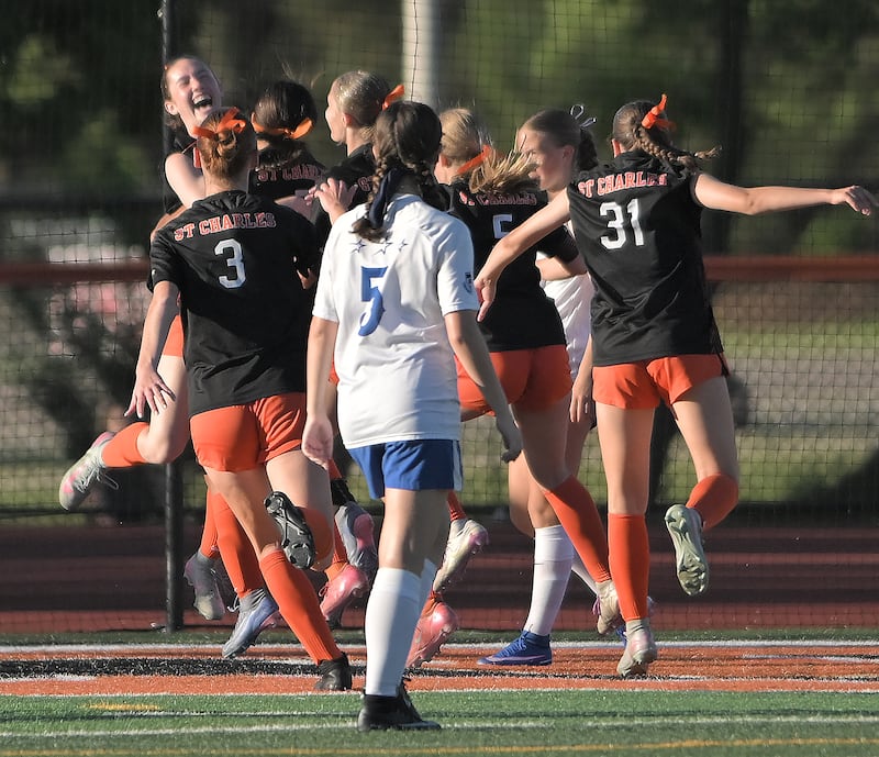 St. Charles East’s Averie Foulkes, left, laughs with teammates after her goal put the Saints ahead of St. Charles North in overtime in the IHSA class 3A girls soccer sectional semifinal game in St. Charles on Tuesday, May 26, 2026.
