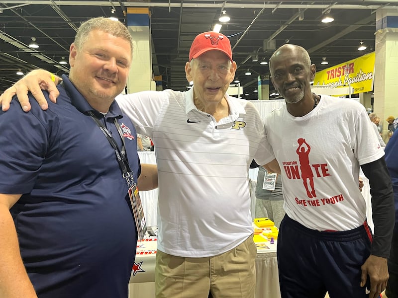 From left, Bourbonnais resident Donnie Daugherty stands with former Chicago Bulls Dave Schellhase and Craig Hodges pose for a photo at the 45th National Sports Card Convention at the Donald E. Stephens Convention Center in Rosemont Friday, August 1, 2025.