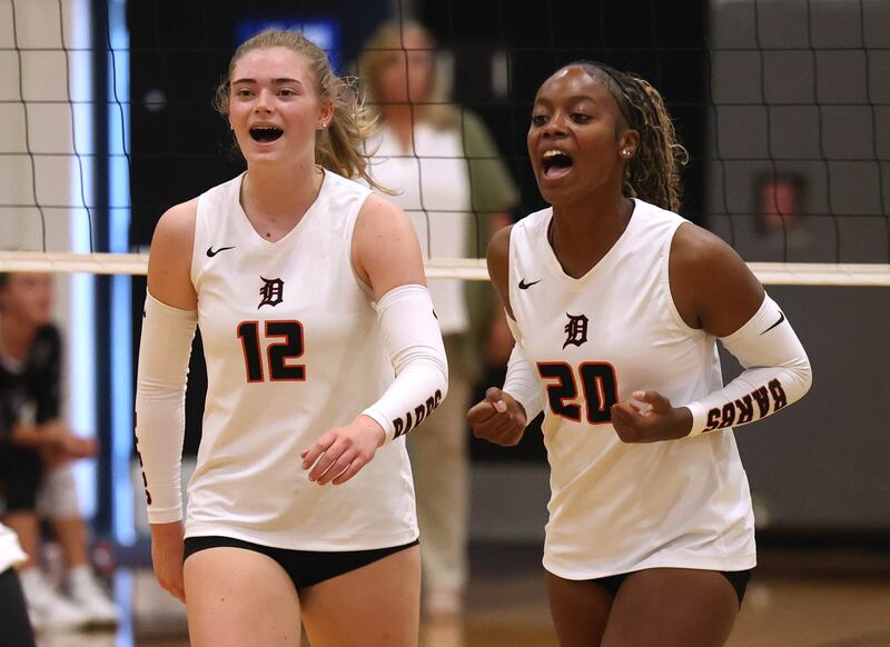 DeKalb's Isabelle Smith (left) and Zora Watts celebrate a point Thursday, Sept. 4, 2025, during their match at Kaneland High School in Maple Park.
