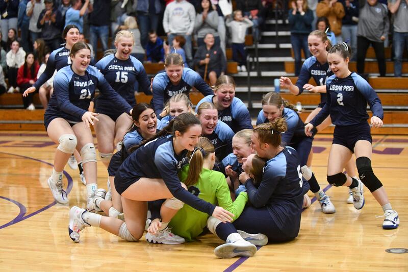 Cissna Park players pile on junior Josie Neukomm, near bottom right, after she scored the game-winning point to secure the Timberwolves' victory in two sets, 20-23, 27-25, over Windsor/Stewardson-Strasburg in the IHSA Class 1A Lexington Super-Sectional.