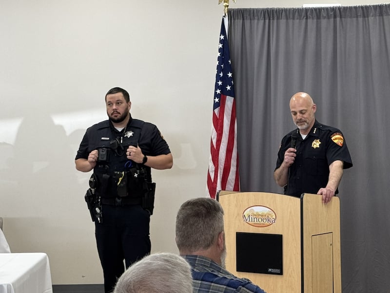 Officer Kyle Vonderheide (left) is honored as Minooka Officer of the Year by Police Chief Justin Meyer.