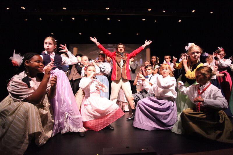 Bryce Verhulst, center, starred as the title character in Woodlawn Arts Academy’s performance of “The Music Man Jr.” this summer. Bryce and the cast of 34 area students were among over 1,100 registrations taken by the Academy this summer amid the Academy’s 20th anniversary celebration.