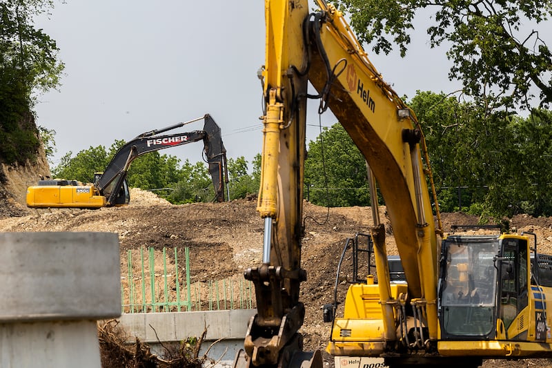 Excavators are seen on the north side of the Rock River Tuesday, June 10, 2025, in Dixon. The pedestrian bridge will cross into Page Park where paths and other improvements are being made.