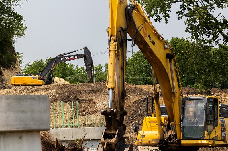 Excavators are seen on the north side of the Rock River Tuesday, June 10, 2025, in Dixon. The pedestrian bridge will cross into Page Park where paths and other improvements are being made.