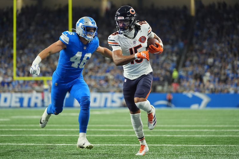 Chicago Bears wide receiver Rome Odunze (15) runs past Detroit Lions linebacker Jack Campbell (46) for a touchdown during the first half of an NFL football game in Detroit, Sunday, Sept. 14, 2025. (AP Photo/Ryan Sun)