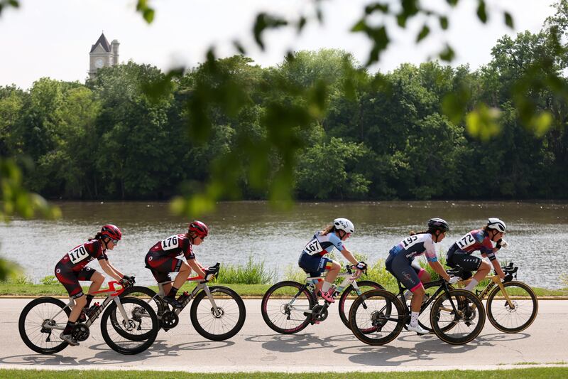 Riders in the Women's Pro Category ride alongside the Kankakee River during the 2025 Cobb Park Criterium on Sunday, June 8, 2025.