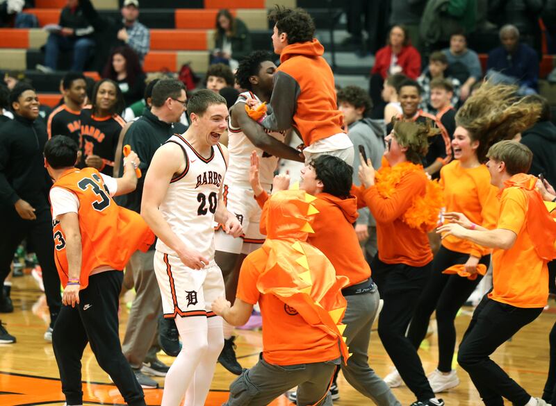 DeKalb fans storm the court after their win over Waubonsie Valley Friday, Feb. 21, 2025, at DeKalb High School.