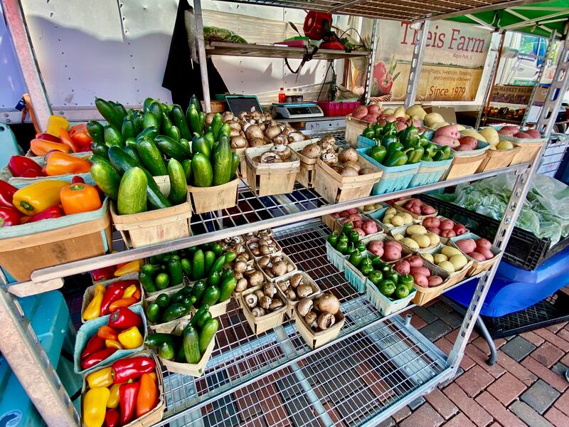 Produce lines the shelves at the Theis Farm Market booth at the opening day of the DeKalb farmers market on Thursday, June 5, 2025, in Van Buer Plaza in downtown DeKalb. The market opened its 30th year Thursday.