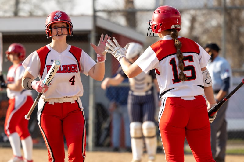 (left) Morgan Kostal (4) of Streator high-fives teammate (right) Caitlin Talty (15) on Wednesday, April 16, 2025 at Streator High School in Streator.
