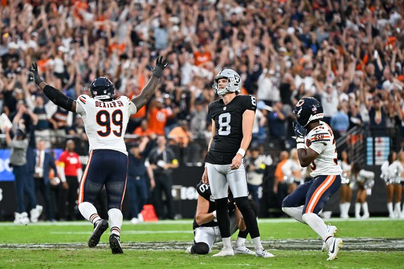 Chicago Bears cornerback Josh Blackwell (39) and defensive tackle Gervon Dexter Sr. (99) celebrate after Blackwell blocked a field goal by Las Vegas Raiders kicker Daniel Carlson (8) during the second half of an NFL football game Sunday, Sept. 28, 2025, in Las Vegas. (AP Photo/David Becker)