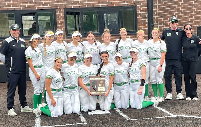 The Seneca softball team poses with its freshly won Class 2A regional championship plaque Friday, May 22, 2026, at Seneca.