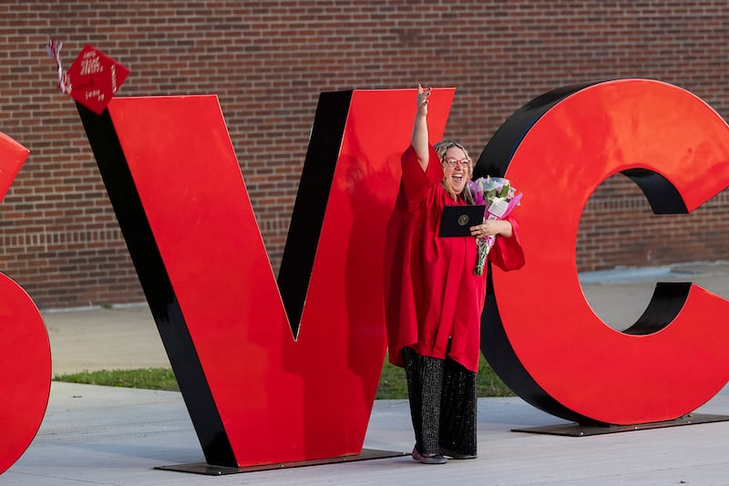 Kayleen Mecum of Morrison fires her hat in the air for pictures Friday, May 9, 2025, after graduating from Sauk Valley Community College.