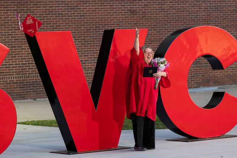 Kayleen Mecum of Morrison fires her hat in the air for pictures Friday, May 9, 2025, after graduating from Sauk Valley Community College.