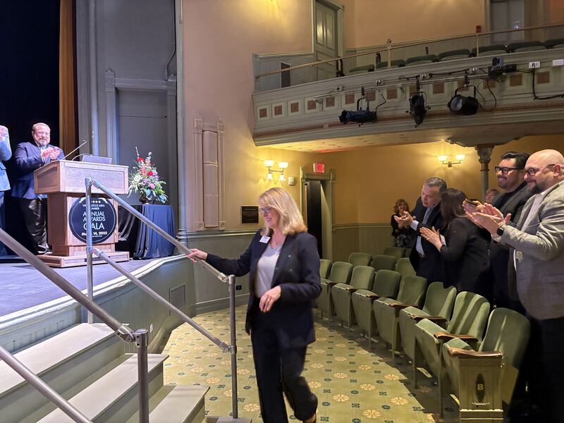 Donna Besler takes the stage to accept the Harold Buschkopf Community Service Award in Woodstock, Friday, March 14. 2025.