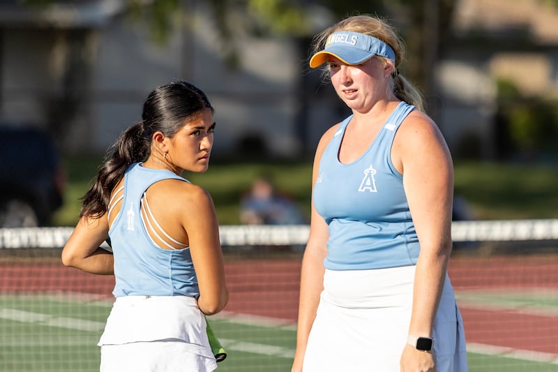 Joliet Catholic Academy’s Alondra Espino and Megan Ardaugh touch base during varsity doubles tennis during a match against Joliet Township at Joliet West on Sept. 29, 2025.