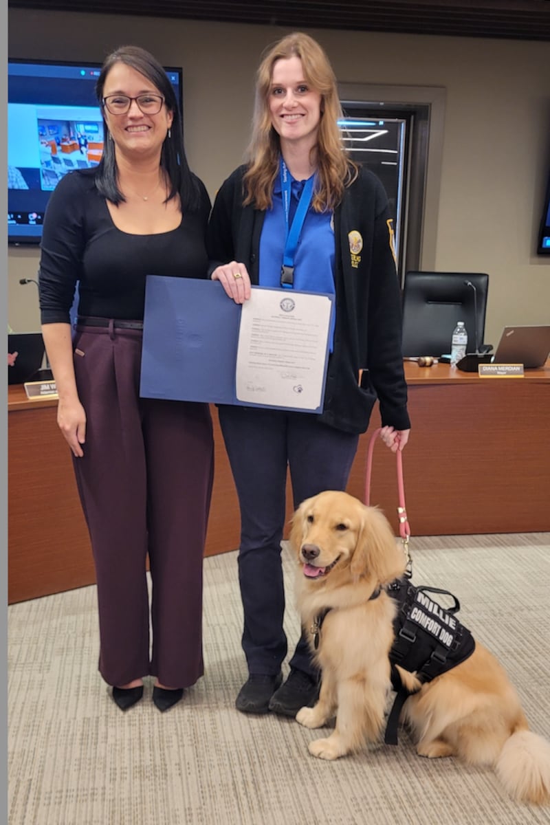 Millie, the Sterling Police Department’s comfort dog, and her handler, Community Service Officer Mary Toth (right), were recognized by Sterling Mayor Diana Merdian (left) and the Sterling City Council on Monday for the work they do and the comfort they provide.
