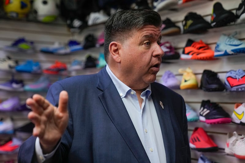 Illinois Gov. J.B. Pritzker visits with members of the family-owned soccer gear business Extreme Soccer, Thursday, Sept. 4, 2025, in Berwyn, Ill. (AP Photo/Erin Hooley)