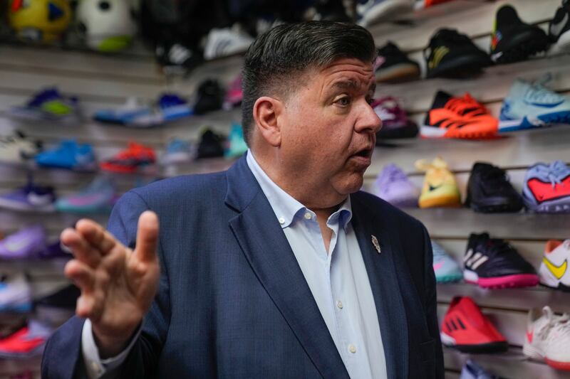 Illinois Gov. J.B. Pritzker visits with members of the family-owned soccer gear business Extreme Soccer, Thursday, Sept. 4, 2025, in Berwyn, Ill. (AP Photo/Erin Hooley)