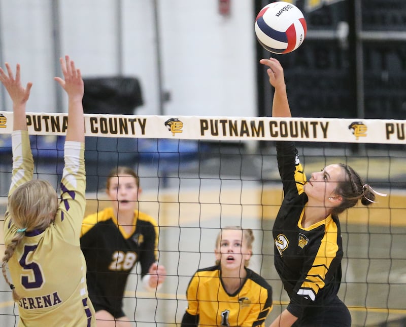 Putnam County's Ella Pyszka sends a spike past Serena's Maddie Young on Monday, Sept. 22, 2025 at Putnam County High School.