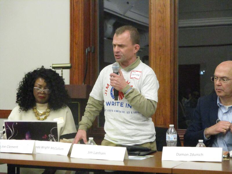 Joliet City Council candidate Jim Lanham, sporting his write-in candidate T-shirt, speaks at a candidates forum on Thursday. Joliet. Feb. 19, 2025