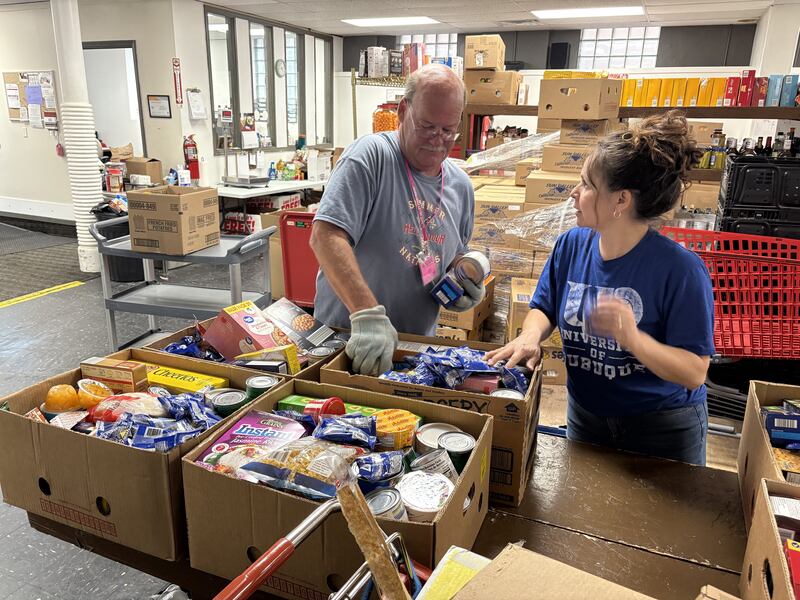 Employee Roy Greening and volunteer Lydia Kriewald pack boxes for distribution recently at the Illinois Valley Food Pantry in downtown La Salle. The pantry recently partnered with Starved Rock Country Community Foundation to create a fund to finance its move to a new home on Progress Boulevard in Peru.