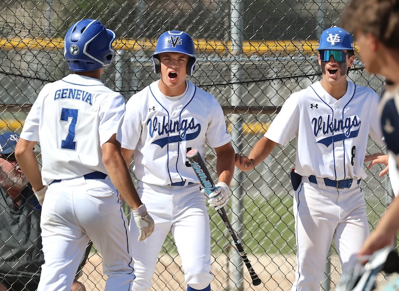 Geneva's Mason Bruesch (left) is congratulated after scoring a run by teammates Nelson Wendell and Nick Lozano (right) Wednesday, June 3, 2026, during their Class 3A sectional semifinal game against Belvidere North at the Sycamore Community Sports Complex.