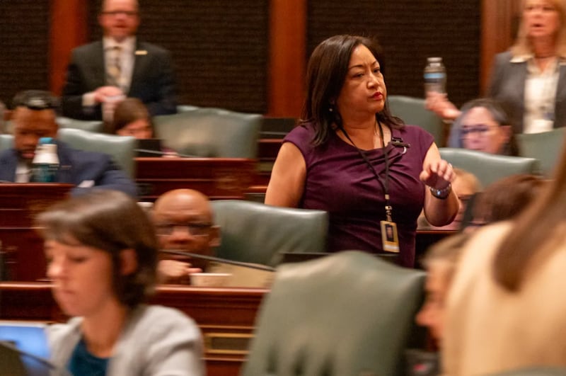 Rep. Theresa Mah, D-Chicago, rushes across the House floor shortly after her bill failed