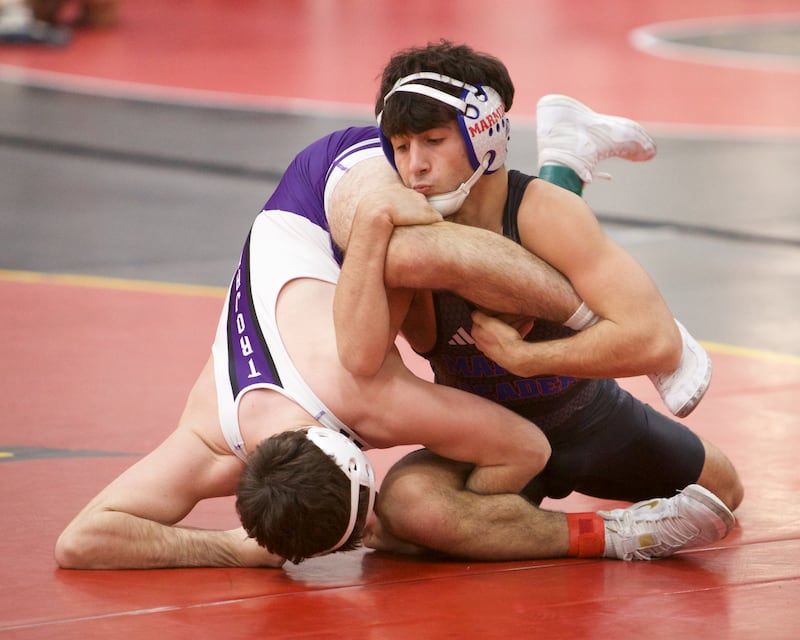 Marmion's Zach Stewart competes against Downers Grove North's Aidan Cummings in the 138 lb weight class at the Clint Arias Invitational on Saturday, Jan.18,2025 in Batavia.