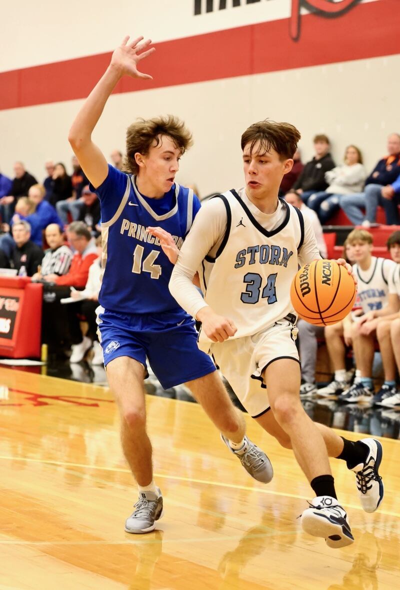Bureau Valley's Carson Gruber drives on Princeton's Jackson Mason during Saturday's Colmone Classic action at Hall High School. The Tigers won 86-83 in double OT.